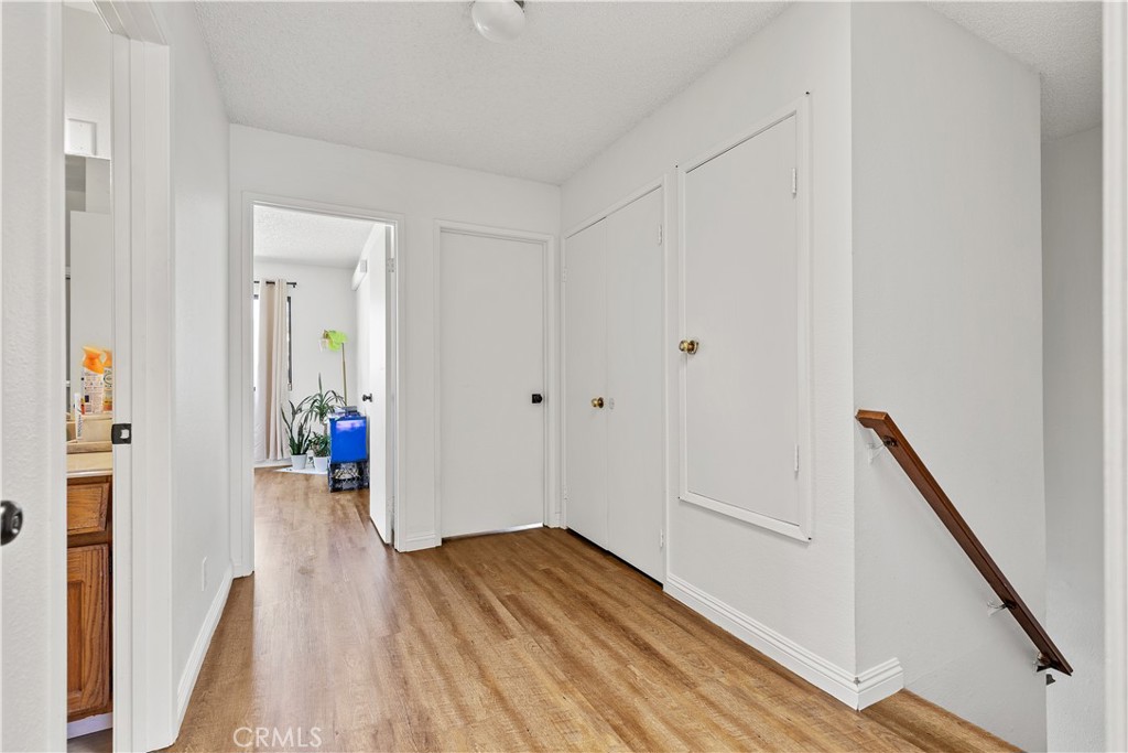 8784 Hewitt Place, Unit 12 Garden Grove, CA 92844 - Photo 44 of 54 a view of a hallway with wooden floor and staircase