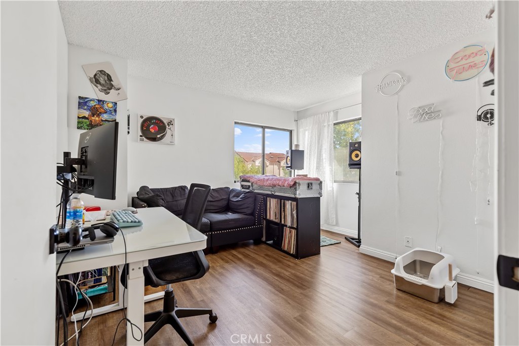 8784 Hewitt Place, Unit 12 Garden Grove, CA 92844 - Photo 48 of 54 a view of a workspace with furniture and wooden floor
