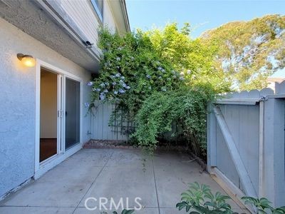 8784 Hewitt Place, Unit 12 Garden Grove, CA 92844 - Photo 49 of 54 a view of backyard with potted plants and wooden fence