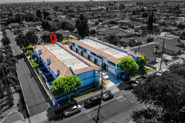 an aerial view of a house with a yard and potted plants