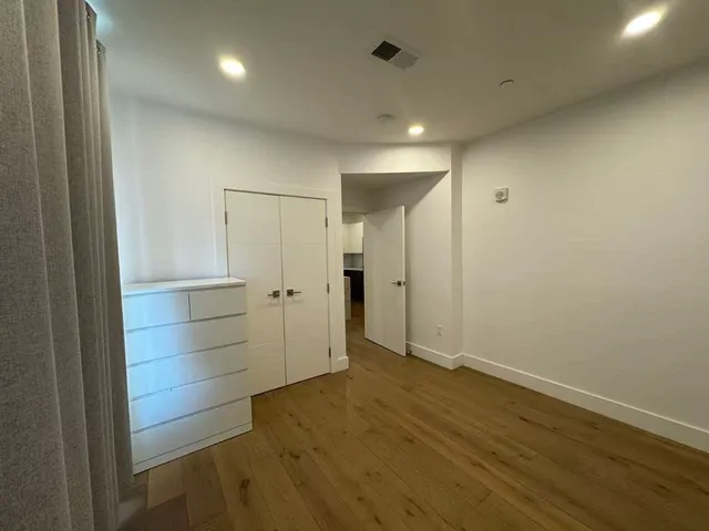 a bathroom with a double vanity sink toilet mirror and shower