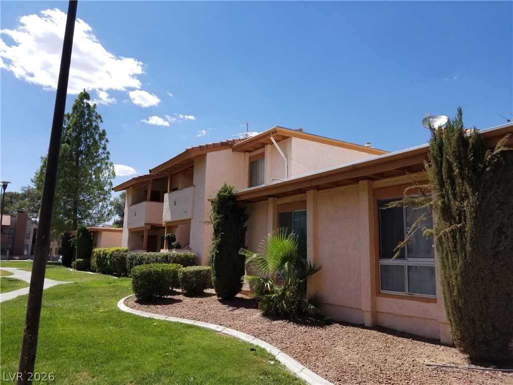 1515 East Reno Avenue, Unit A103 Las Vegas, NV 89119 - Photo 2 of 16 This charming multi-level residence features well-maintained landscaping and a classic architectural facade.