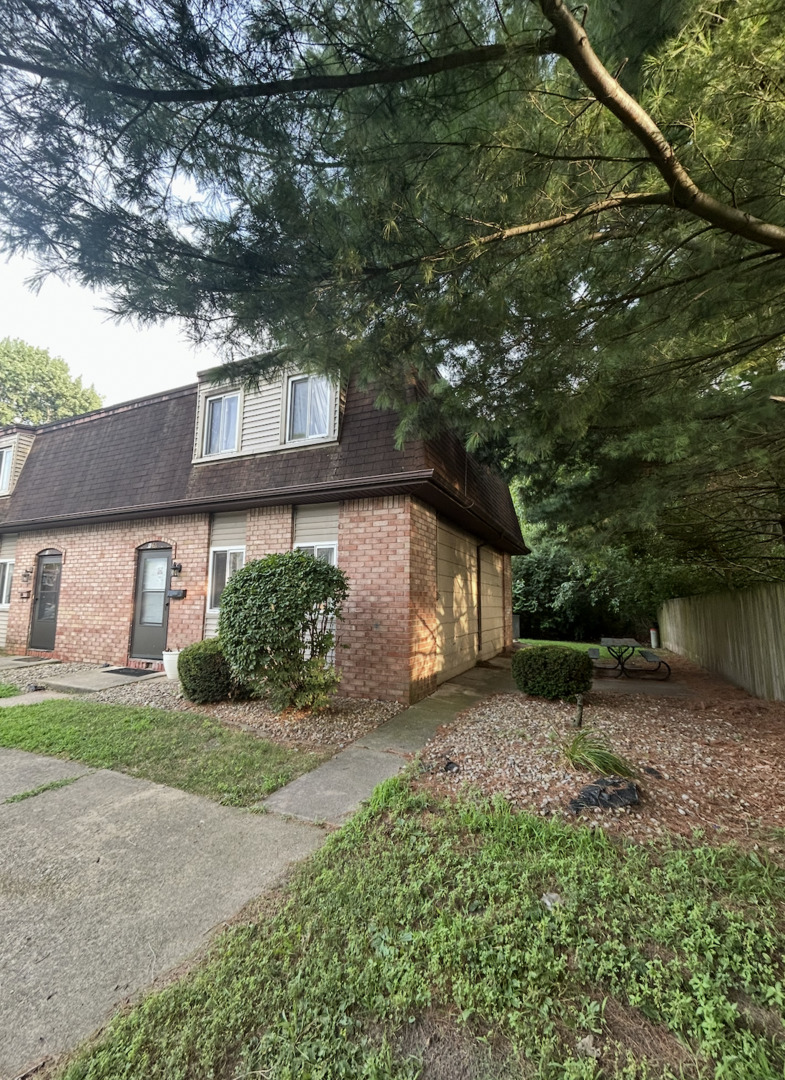 1119 South Curtis Avenue, Unit F64 Kankakee, IL 60901 - Photo 1 of 13 a front view of a house with a yard and garage