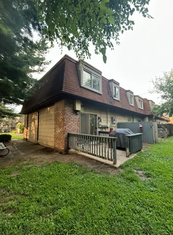 a view of a house with a yard and deck