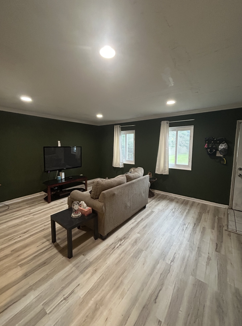 1119 South Curtis Avenue, Unit F64 Kankakee, IL 60901 - Photo 2 of 13 a living room with furniture and a flat screen tv