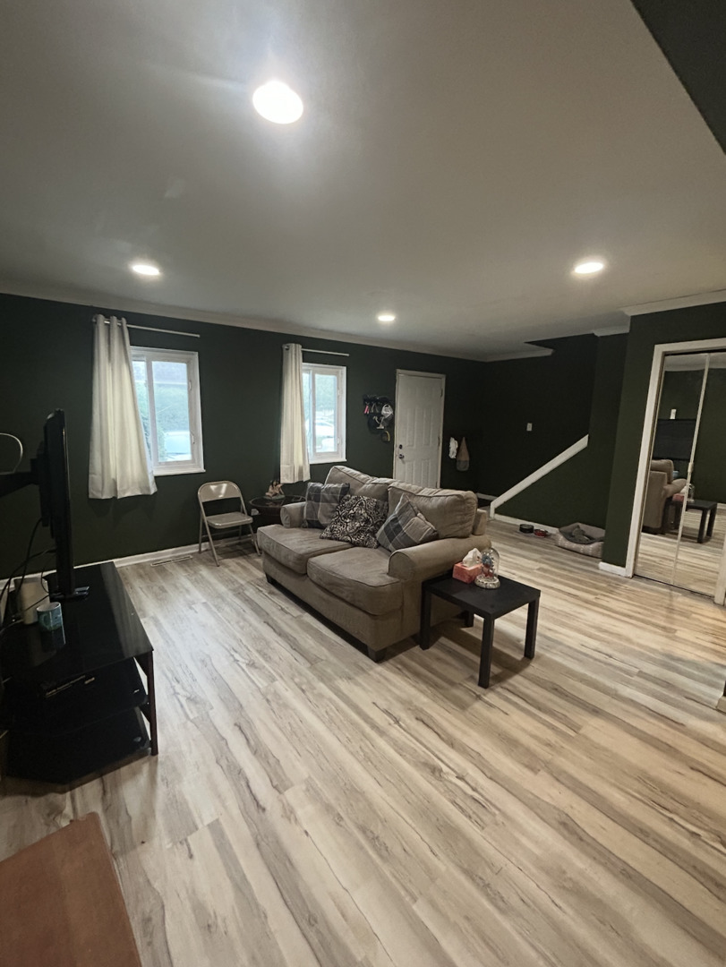 1119 South Curtis Avenue, Unit F64 Kankakee, IL 60901 - Photo 3 of 13 a spacious bedroom with a bed a mirror and gym equipment