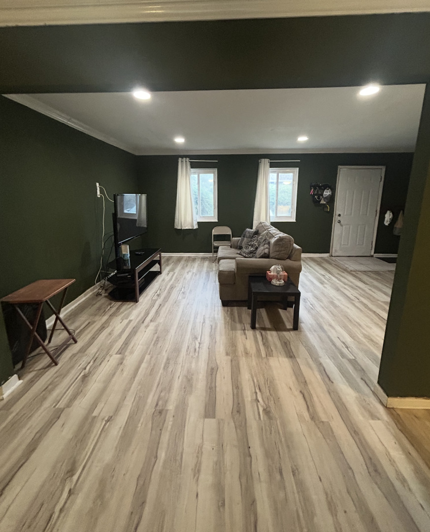 1119 South Curtis Avenue, Unit F64 Kankakee, IL 60901 - Photo 4 of 13 a living room with furniture and a wooden floor