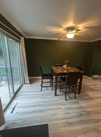 a view of a dining room with furniture and wooden floor