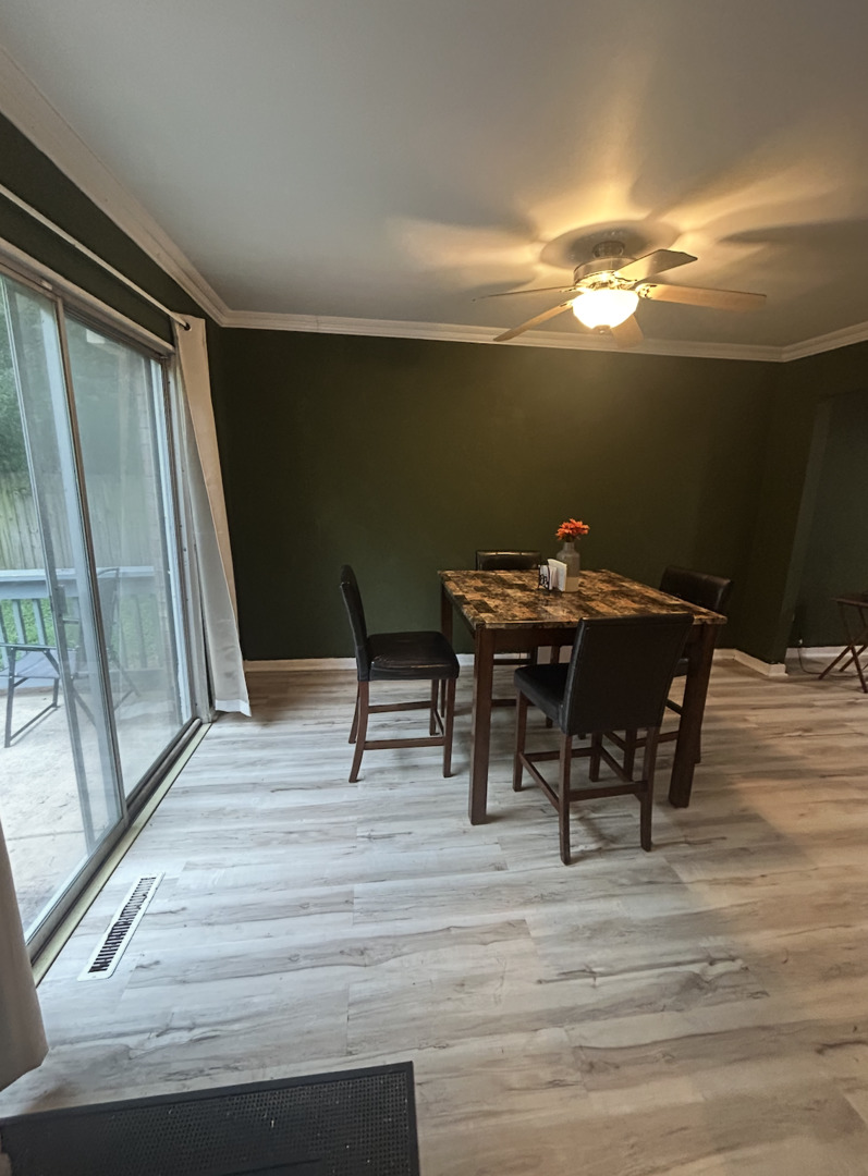 1119 South Curtis Avenue, Unit F64 Kankakee, IL 60901 - Photo 5 of 13 a view of a dining room with furniture and wooden floor