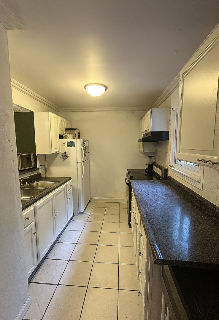 1119 South Curtis Avenue, Unit F64 Kankakee, IL 60901 - Photo 6 of 13 a kitchen with a sink a stove and cabinets