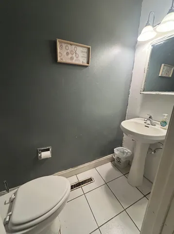 a white toilet sitting next to a bathroom sink