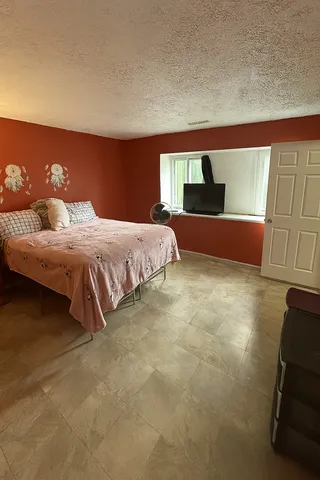 a bedroom with a bed and window