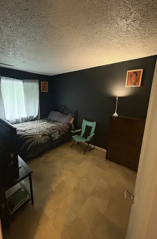 a bedroom with a bed and cabinets