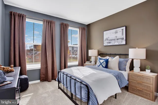 a bedroom with a bed a couch and a window