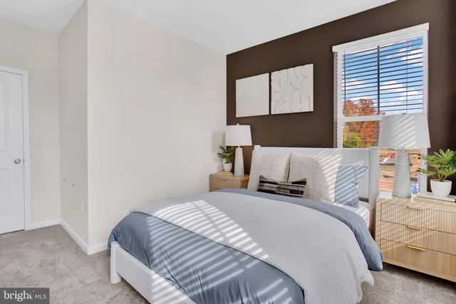 a bedroom with a bed and window