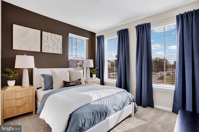 a bedroom with a large bed and a large window