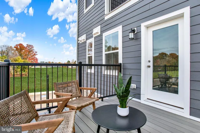 a view of a balcony with couch and potted plants