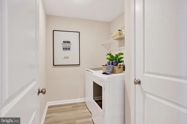 a room with a door open and a white couch