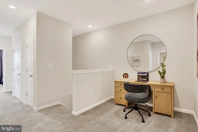 a workspace with furniture and a mirror