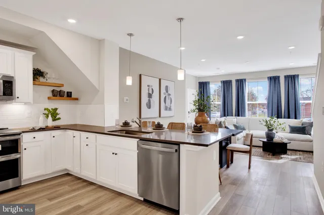 a kitchen with counter space sink and living room