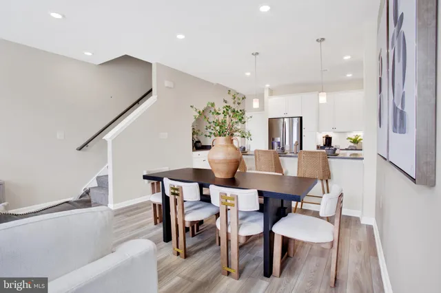 a dining room with furniture and wooden floor