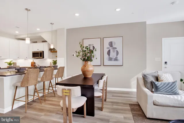 a living room with furniture and kitchen view
