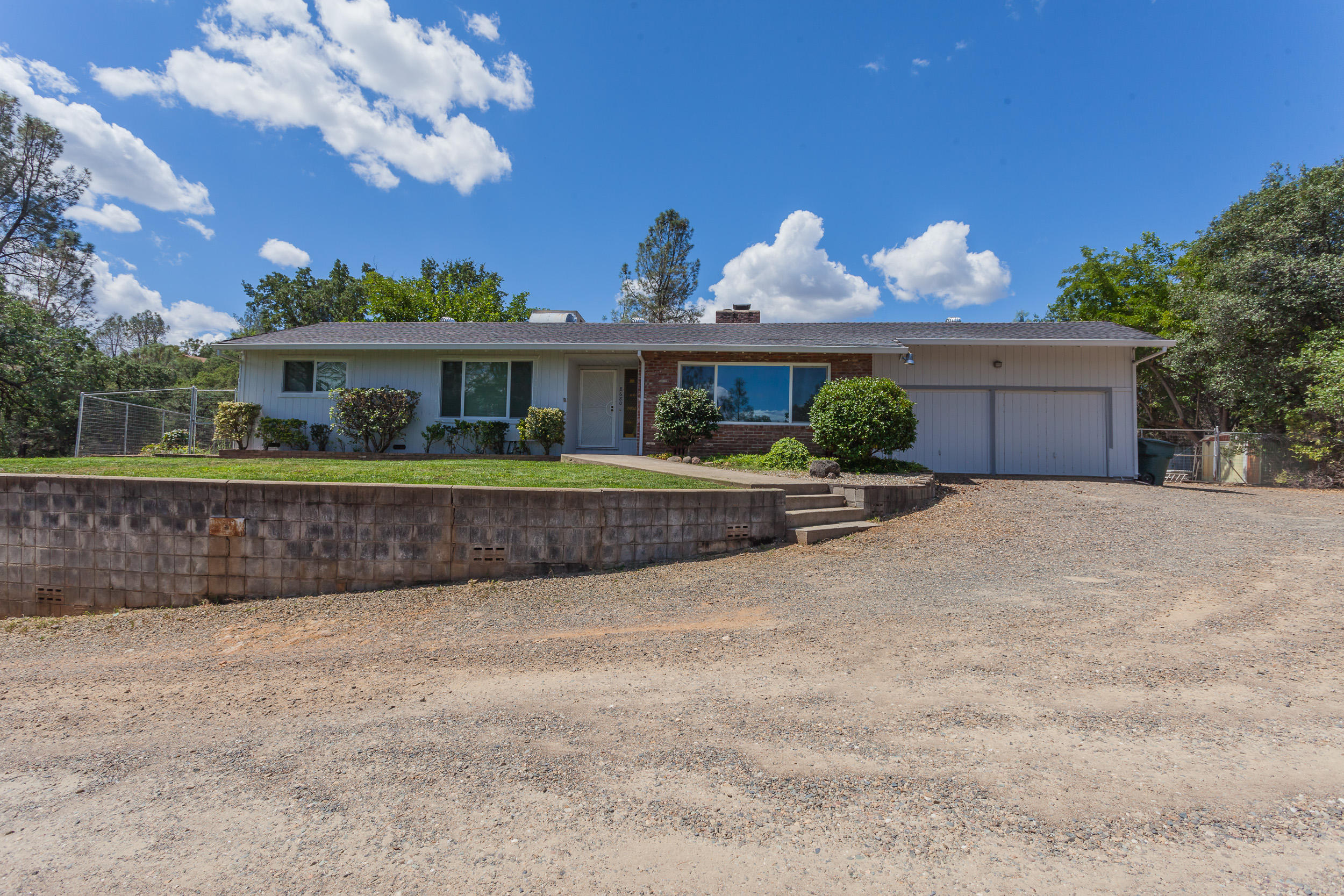 8680 Valley View Road Redding, CA 96001 - Photo 1 of 33 a front view of a house with a yard and outdoor seating