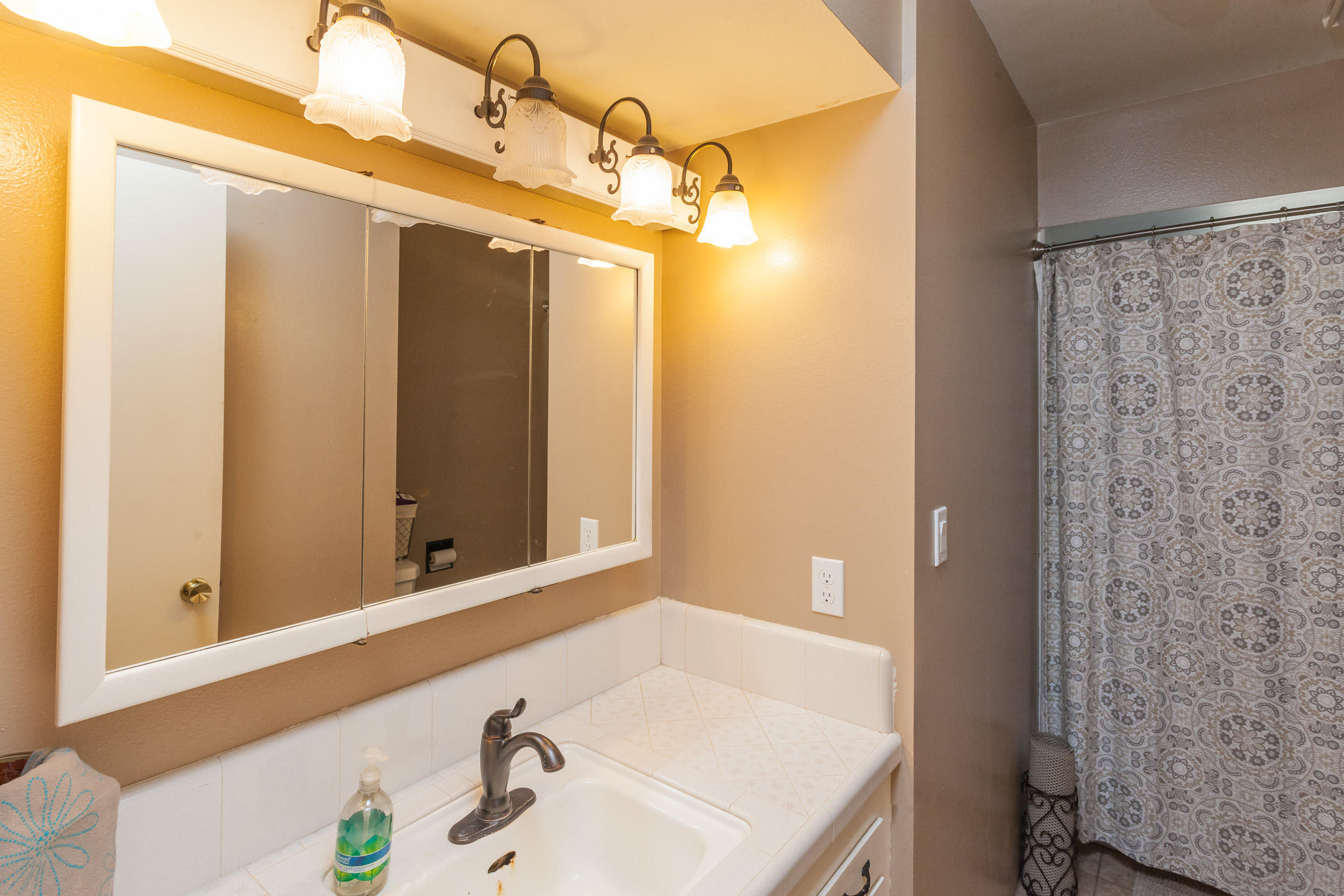 8680 Valley View Road Redding, CA 96001 - Photo 14 of 33 a bathroom with a sink and a mirror
