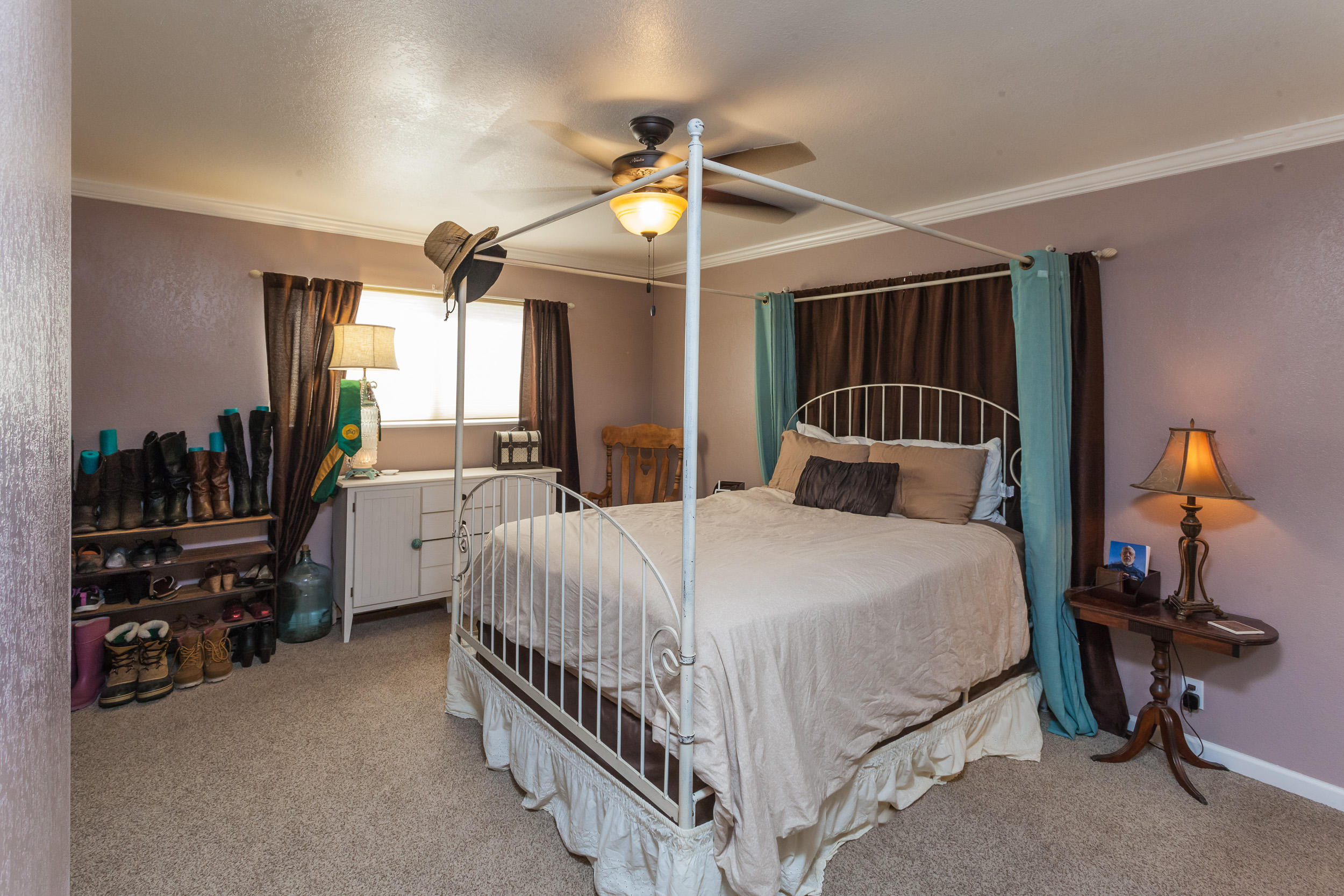 8680 Valley View Road Redding, CA 96001 - Photo 15 of 33 a bedroom with a bed and a chandelier