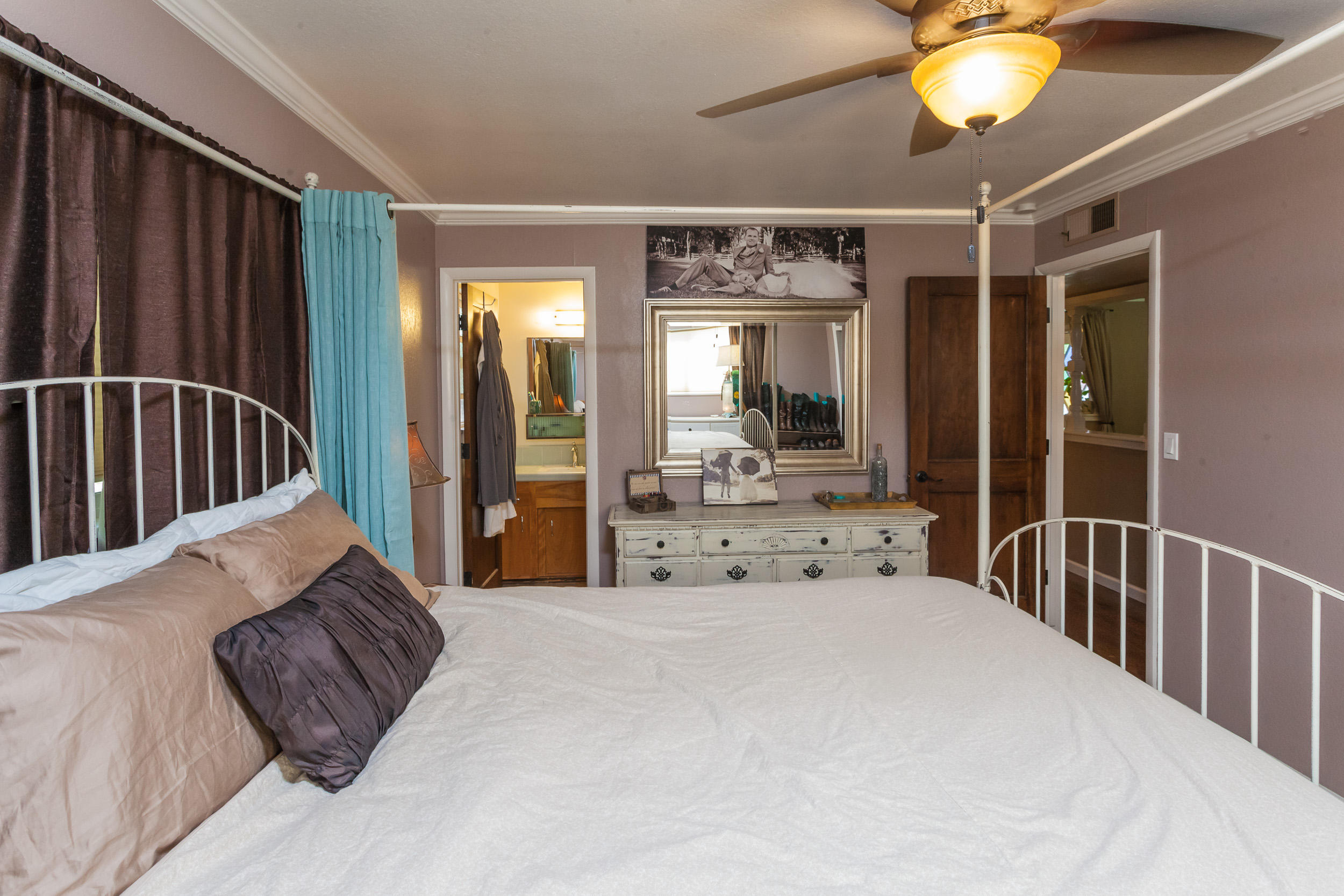 8680 Valley View Road Redding, CA 96001 - Photo 17 of 33 a large bedroom with a large bed and a chandelier