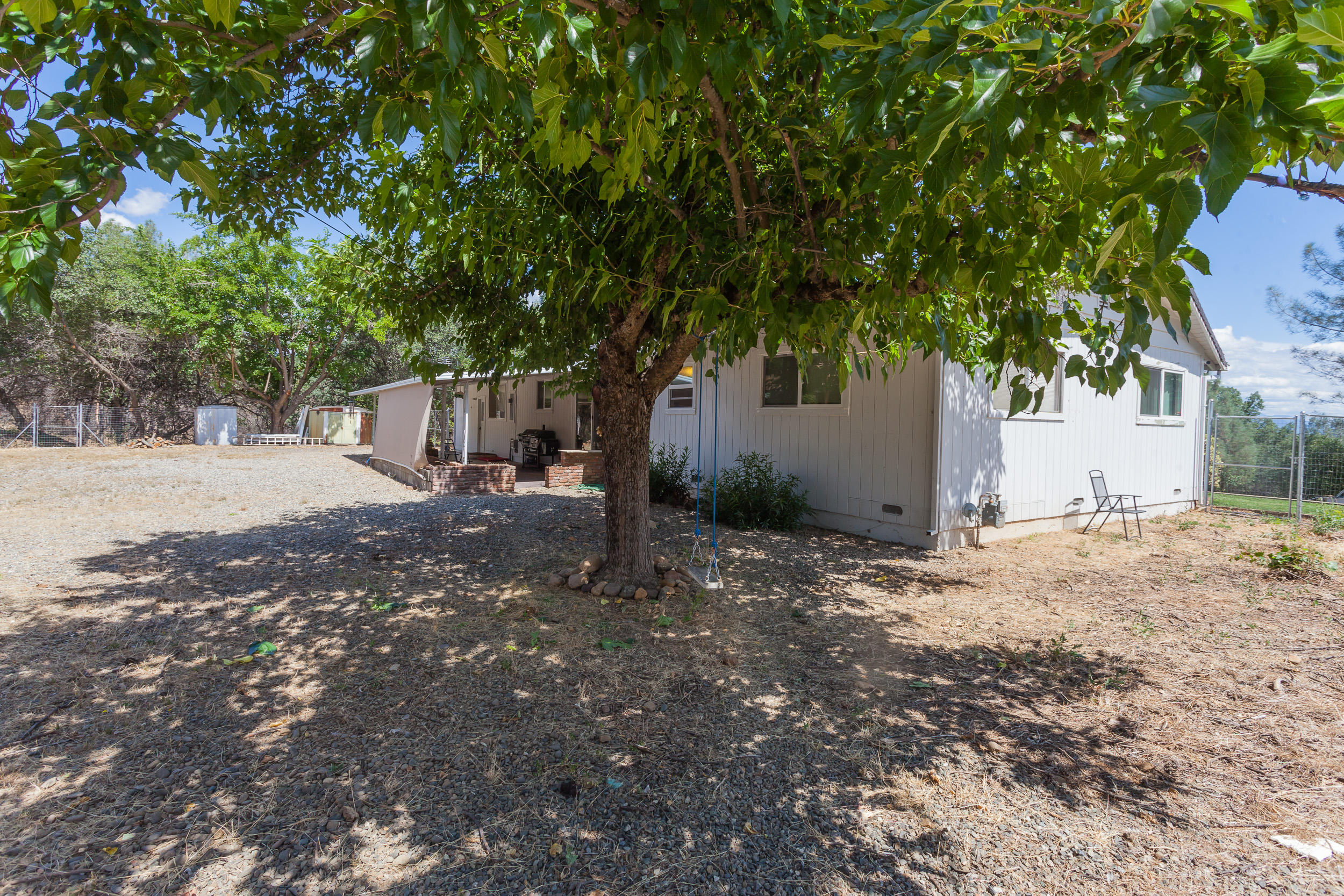 8680 Valley View Road Redding, CA 96001 - Photo 27 of 33 a view of a yard with a tree