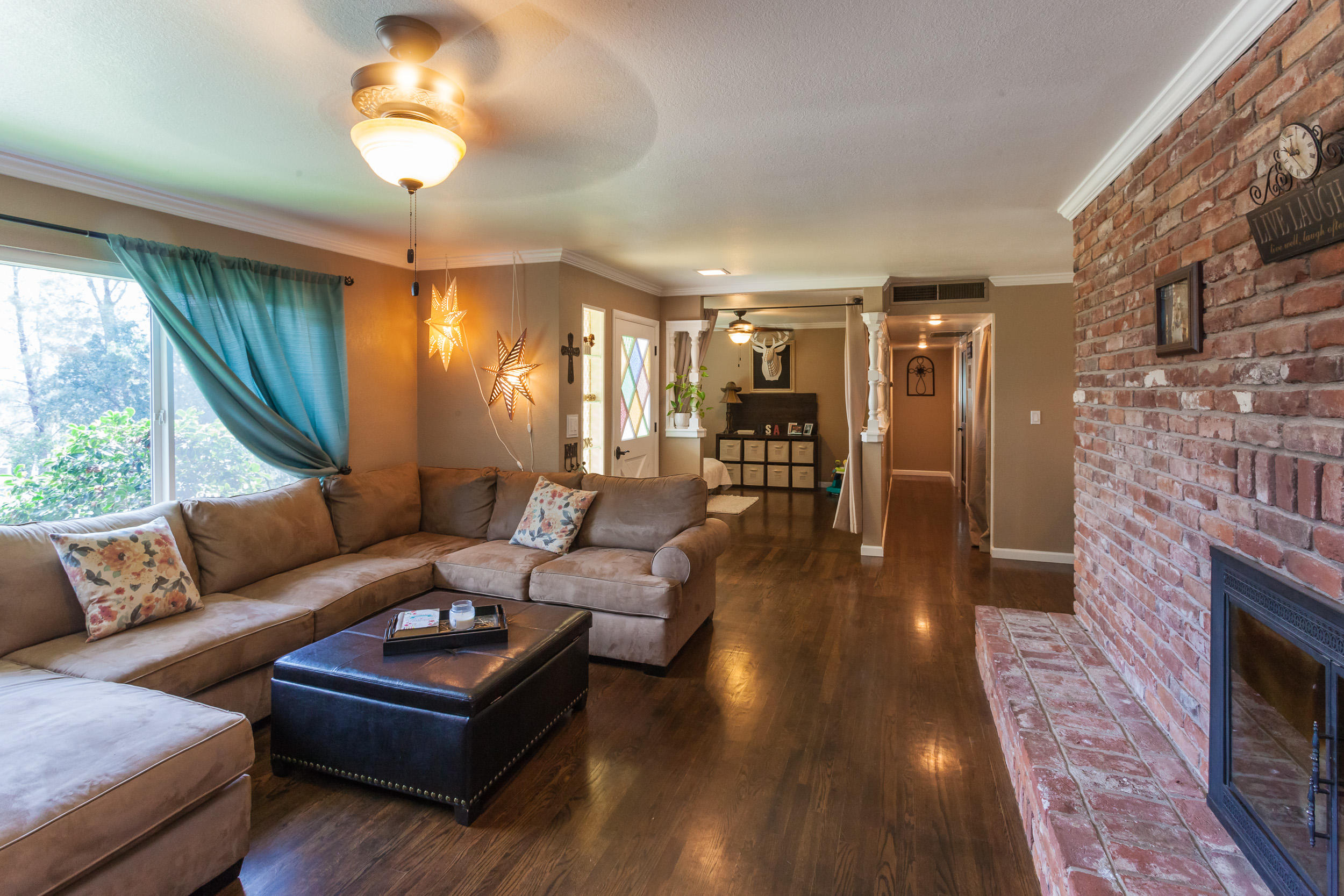 8680 Valley View Road Redding, CA 96001 - Photo 3 of 33 a living room with fireplace furniture and a large window
