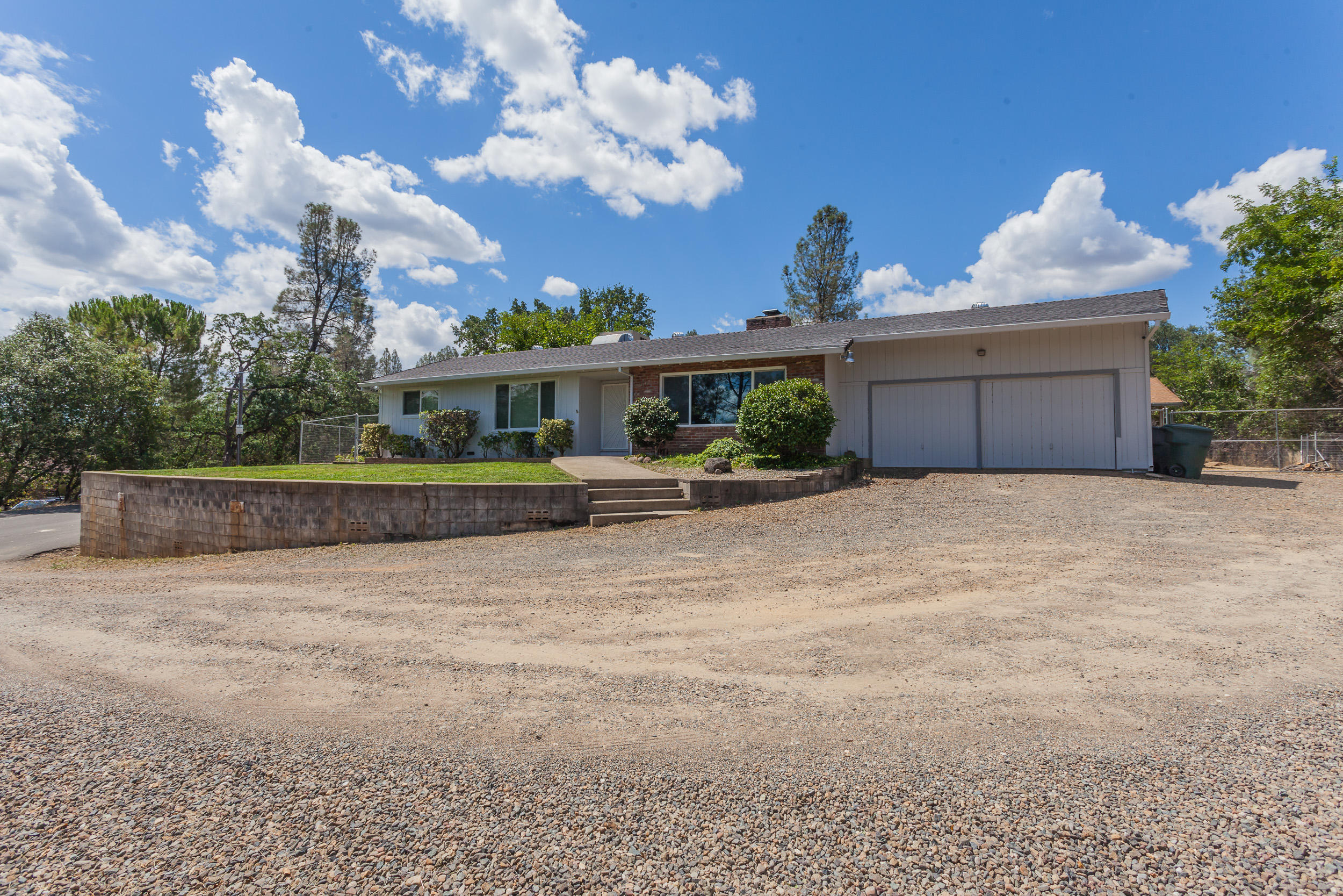 8680 Valley View Road Redding, CA 96001 - Photo 31 of 33 a view of a house with a yard and potted plants