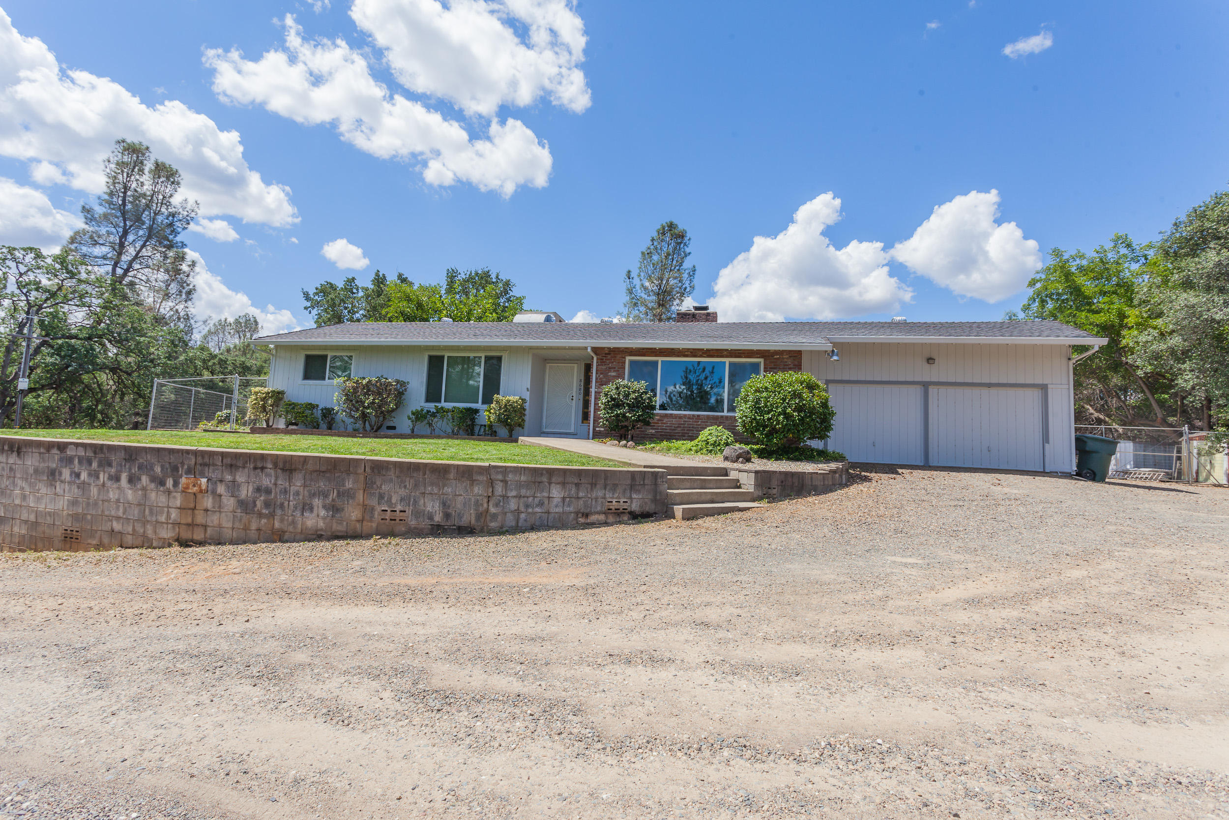 8680 Valley View Road Redding, CA 96001 - Photo 33 of 33 a front view of a house with a yard and potted plants