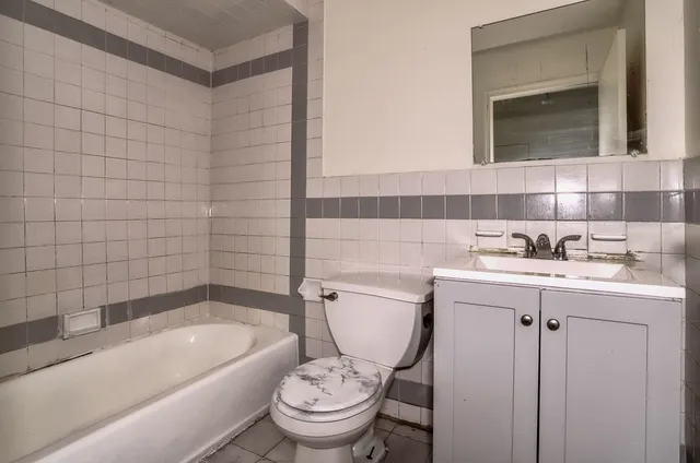 a bathroom with a sink a toilet and bathtub