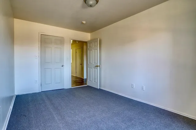 an empty room with closet area