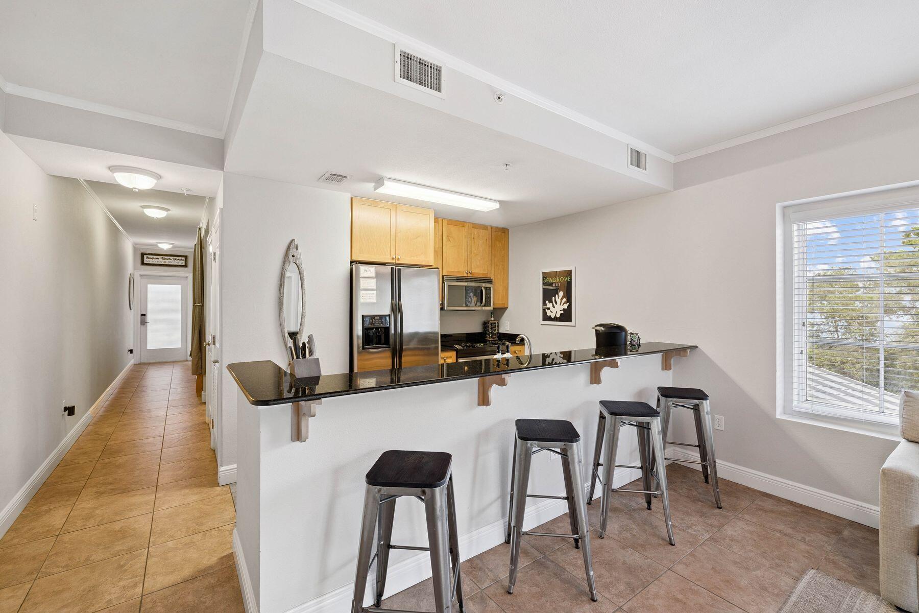 43 Cassine Way, Unit 207 Santa Rosa Beach, FL 32459 - Photo 17 of 28 a view of a dining room with furniture and a large window