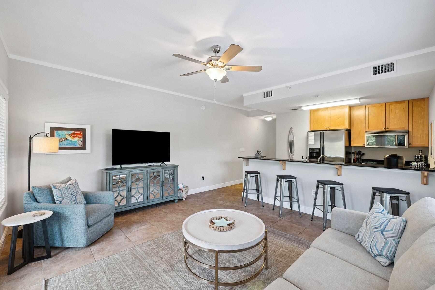 43 Cassine Way, Unit 207 Santa Rosa Beach, FL 32459 - Photo 18 of 28 a living room with furniture a flat screen tv and a window