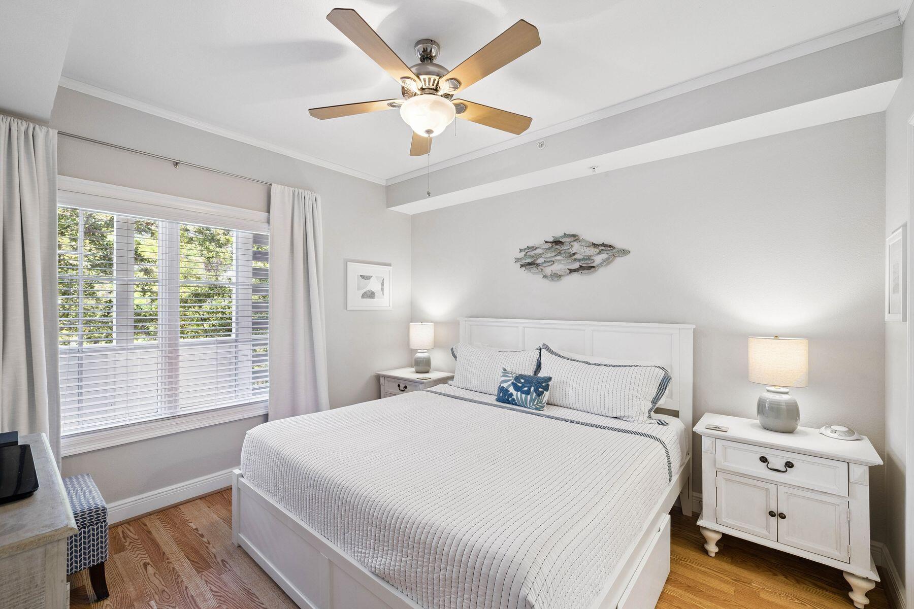 43 Cassine Way, Unit 207 Santa Rosa Beach, FL 32459 - Photo 5 of 28 a bedroom with a large bed and a chandelier