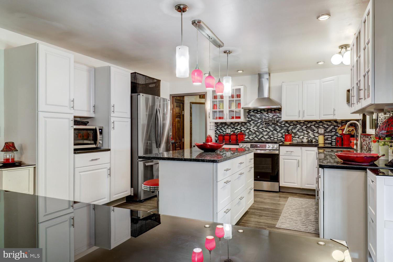 912 Perry Road Lititz, PA 17543 - Photo 15 of 50 a kitchen with stainless steel appliances kitchen island granite countertop a refrigerator and a stove
