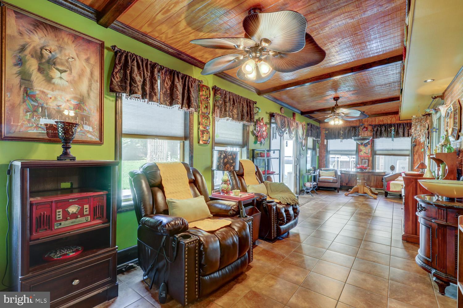 912 Perry Road Lititz, PA 17543 - Photo 20 of 50 a living room with furniture a flat screen tv and a floor to ceiling window