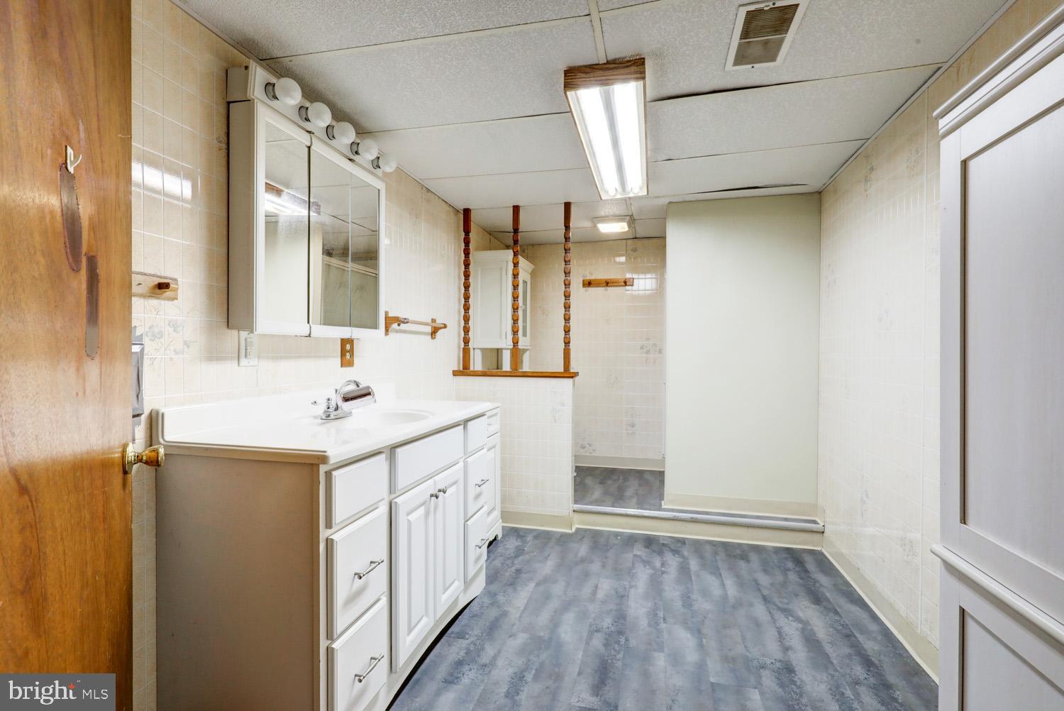 912 Perry Road Lititz, PA 17543 - Photo 40 of 50 a bathroom with a sink a mirror and a shower
