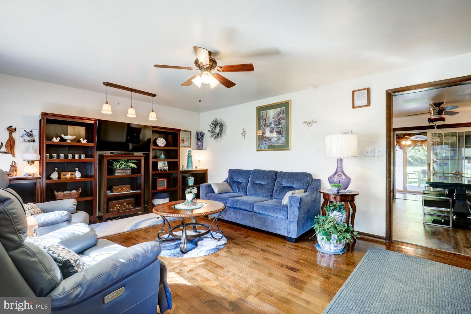 912 Perry Road Lititz, PA 17543 - Photo 7 of 50 a living room with furniture a ceiling fan and a bookshelf