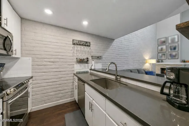 a workspace with furniture wooden floor and a flat screen tv
