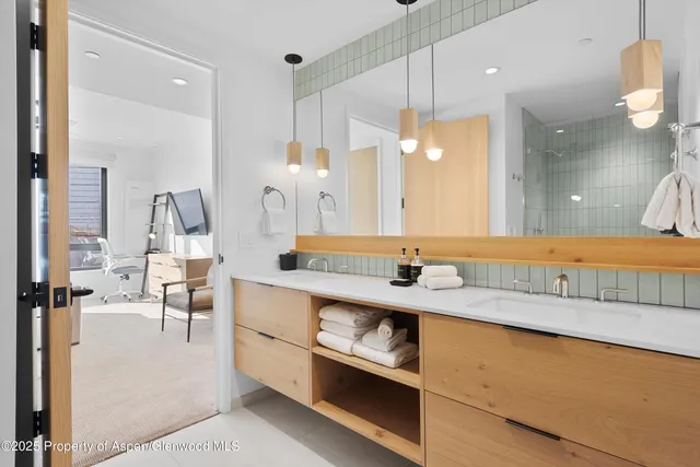 a bathroom with a sink double vanity and mirror