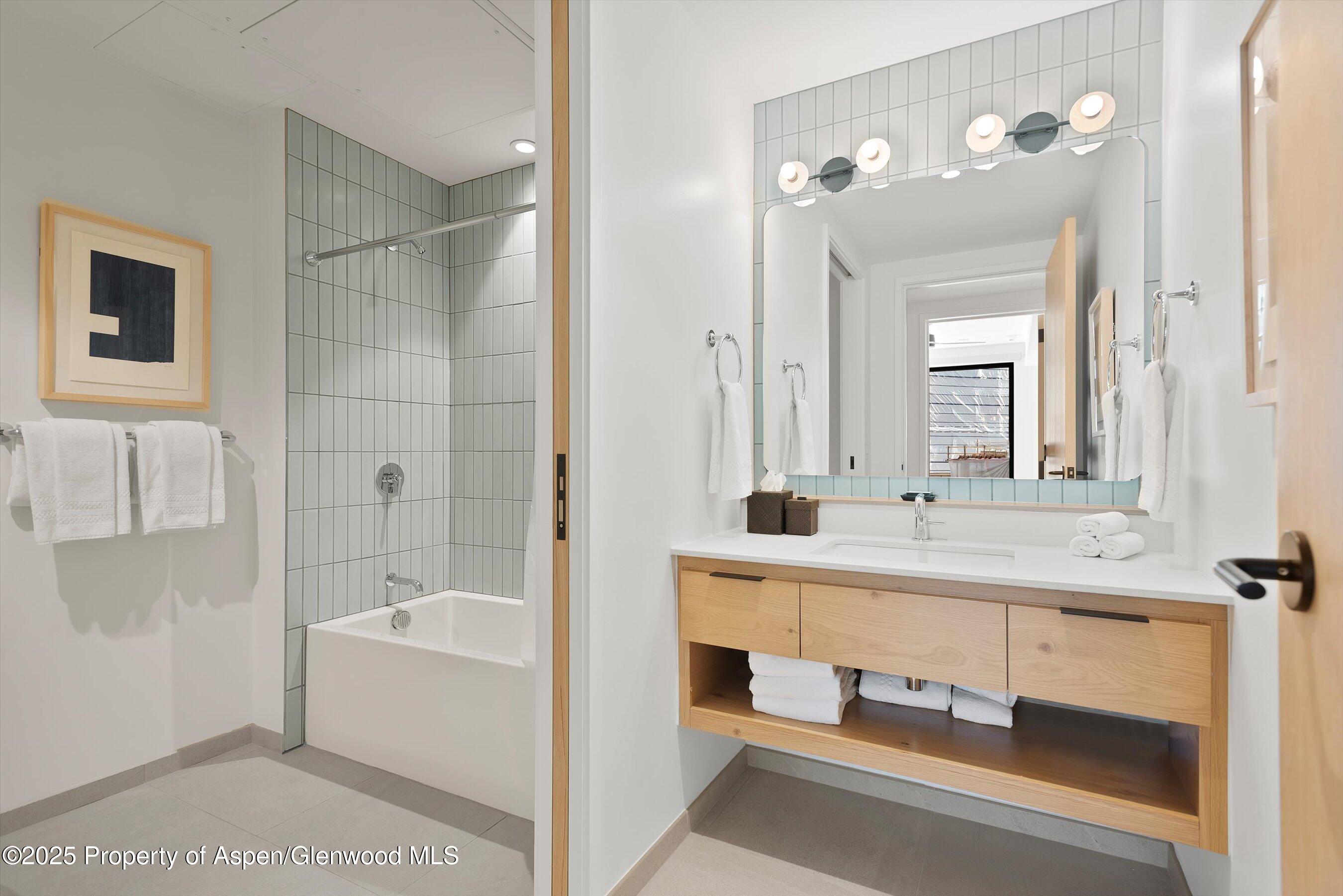119 Wood Road, Unit 303 Snowmass Village, CO 81615 - Photo 14 of 30 a bathroom with a tub sink and mirror