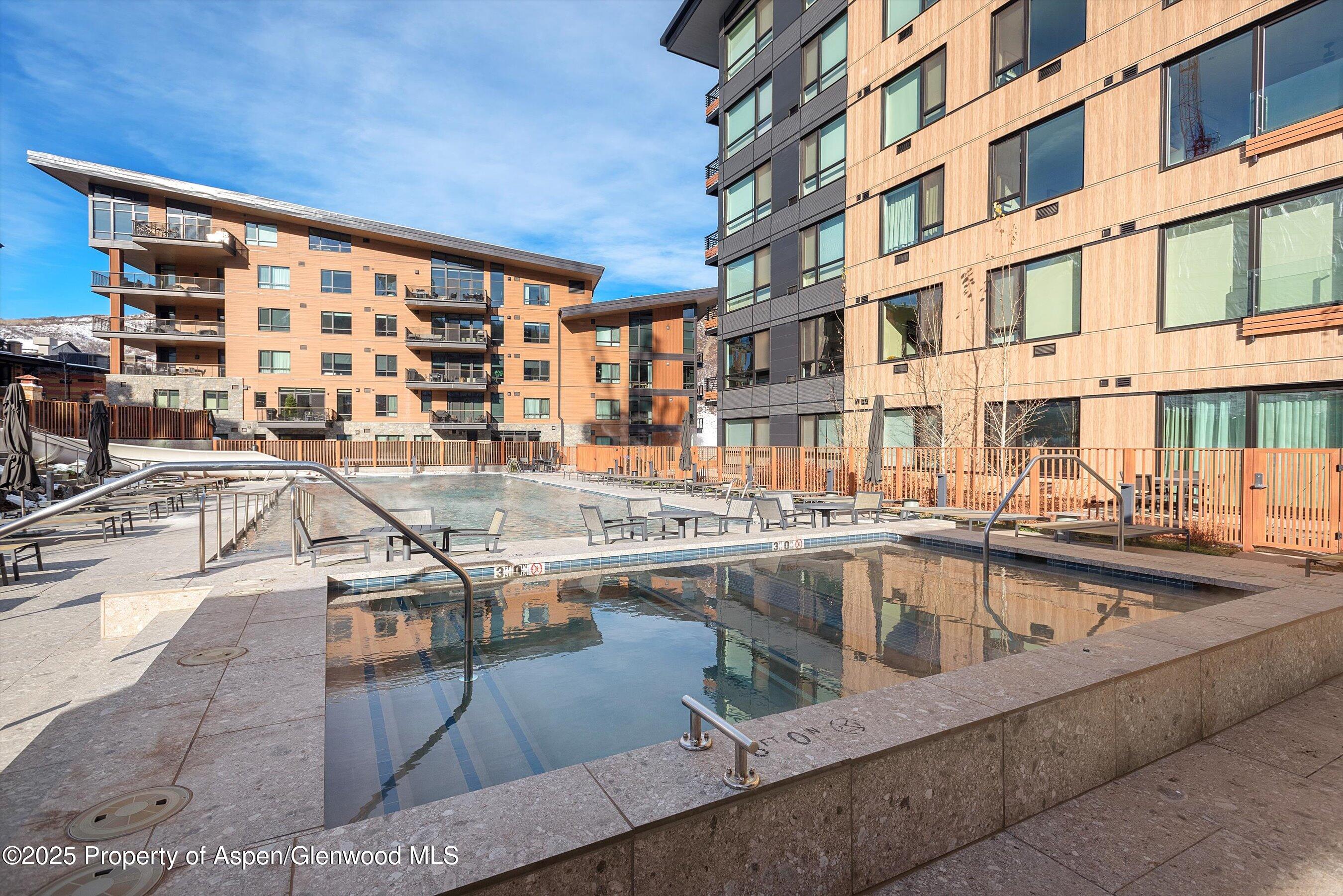 119 Wood Road, Unit 303 Snowmass Village, CO 81615 - Photo 18 of 30 a view of a swimming pool with outdoor seating