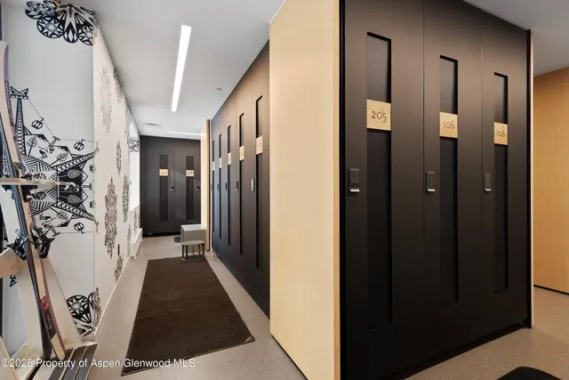 a view of a hallway with wooden shelves