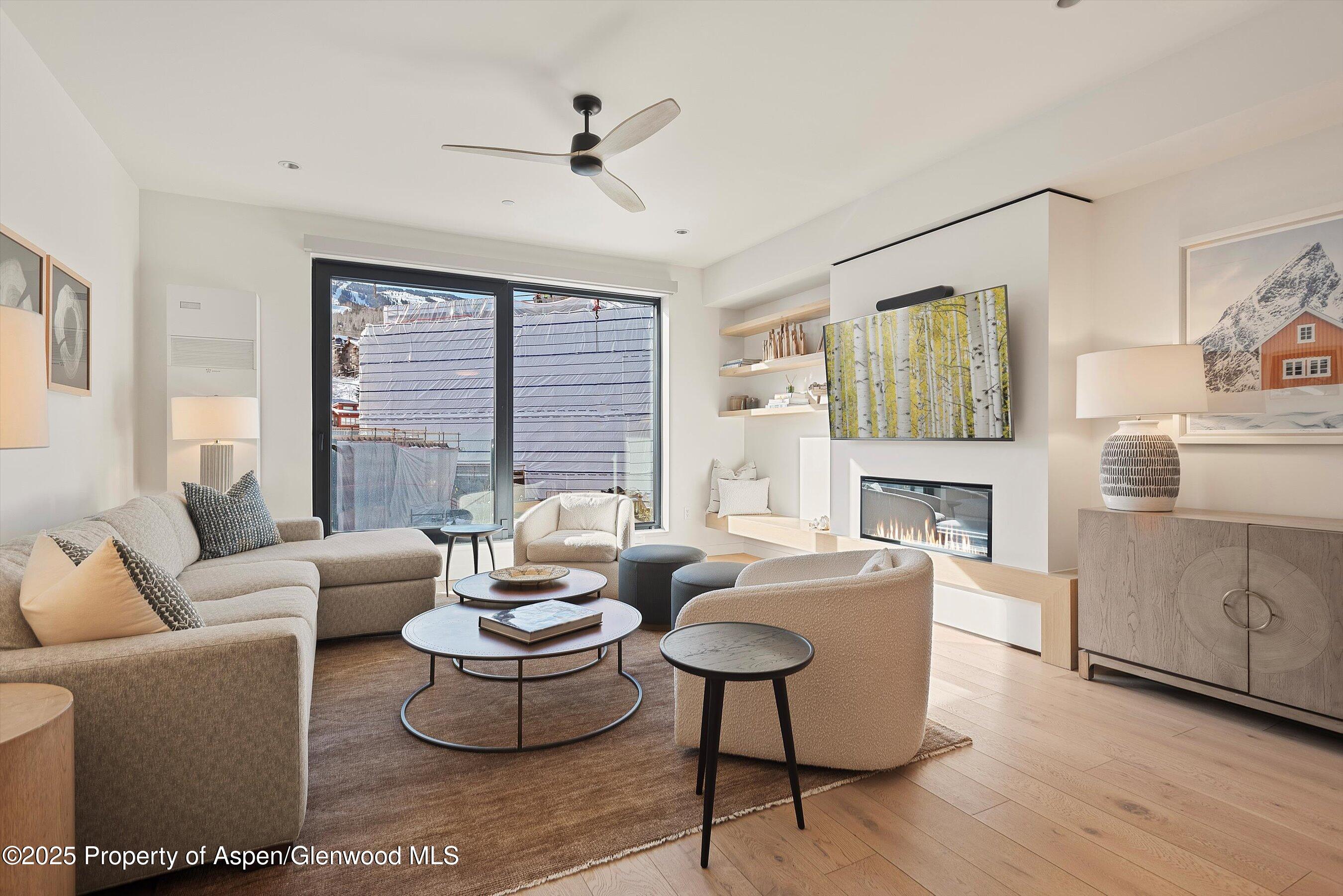 119 Wood Road, Unit 303 Snowmass Village, CO 81615 - Photo 3 of 30 a living room with furniture and a large window