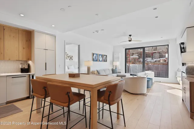 a view of a dining room with furniture and chandelier